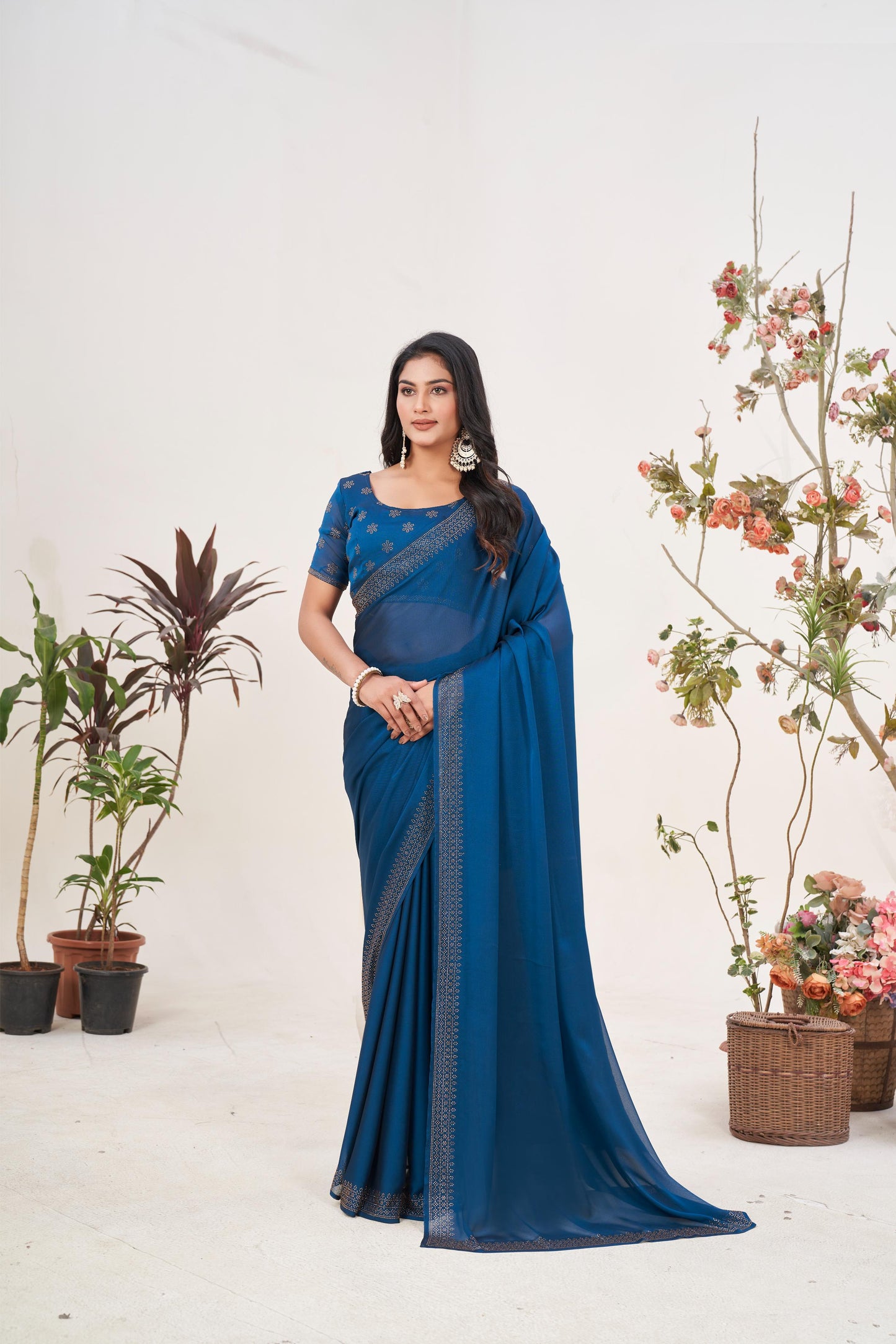 Enchanting Turquoise Blue Georgette Saree with Sarvoski Stone Border