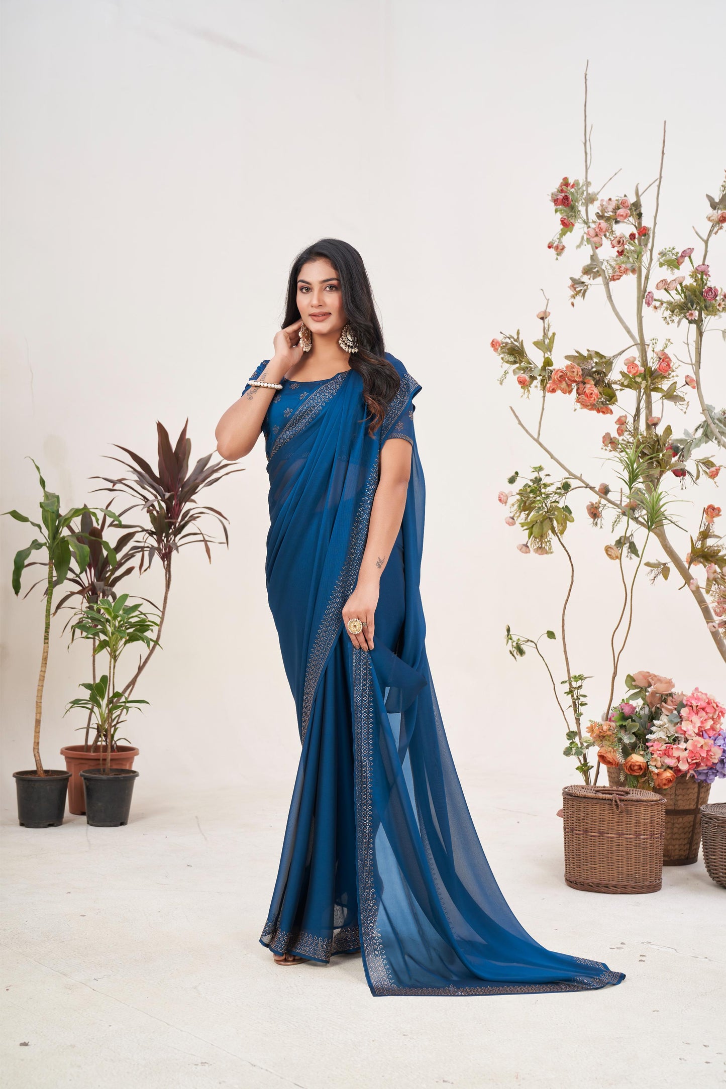 Enchanting Turquoise Blue Georgette Saree with Sarvoski Stone Border