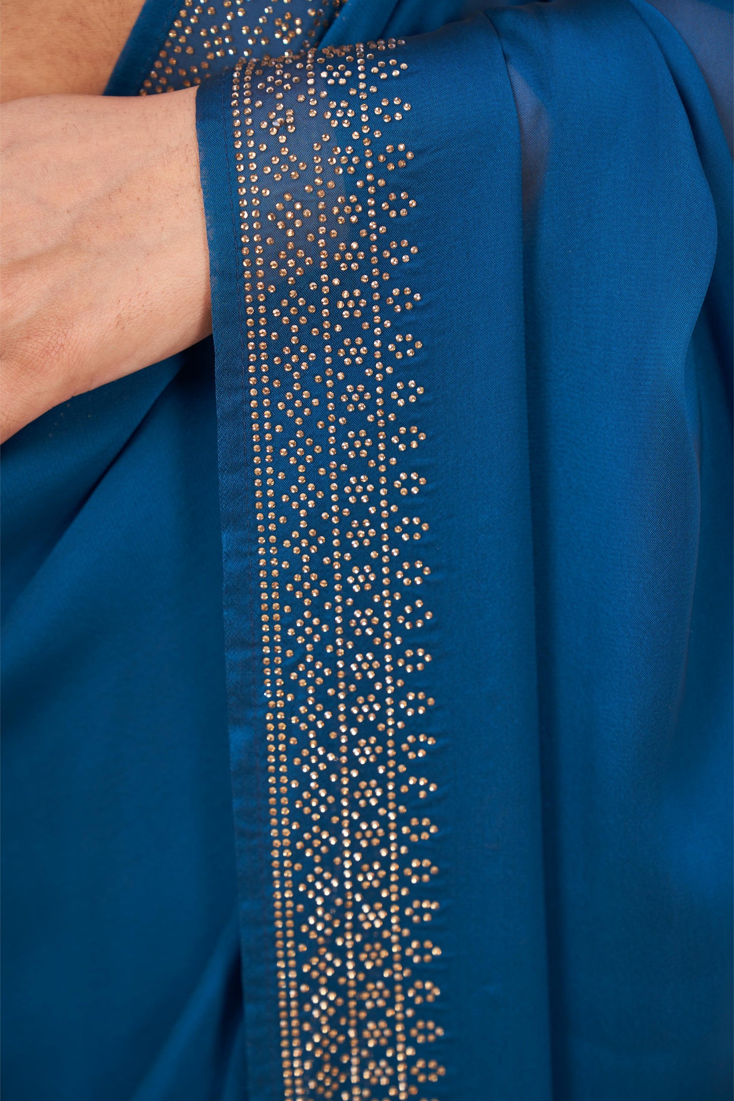 Enchanting Turquoise Blue Georgette Saree with Sarvoski Stone Border