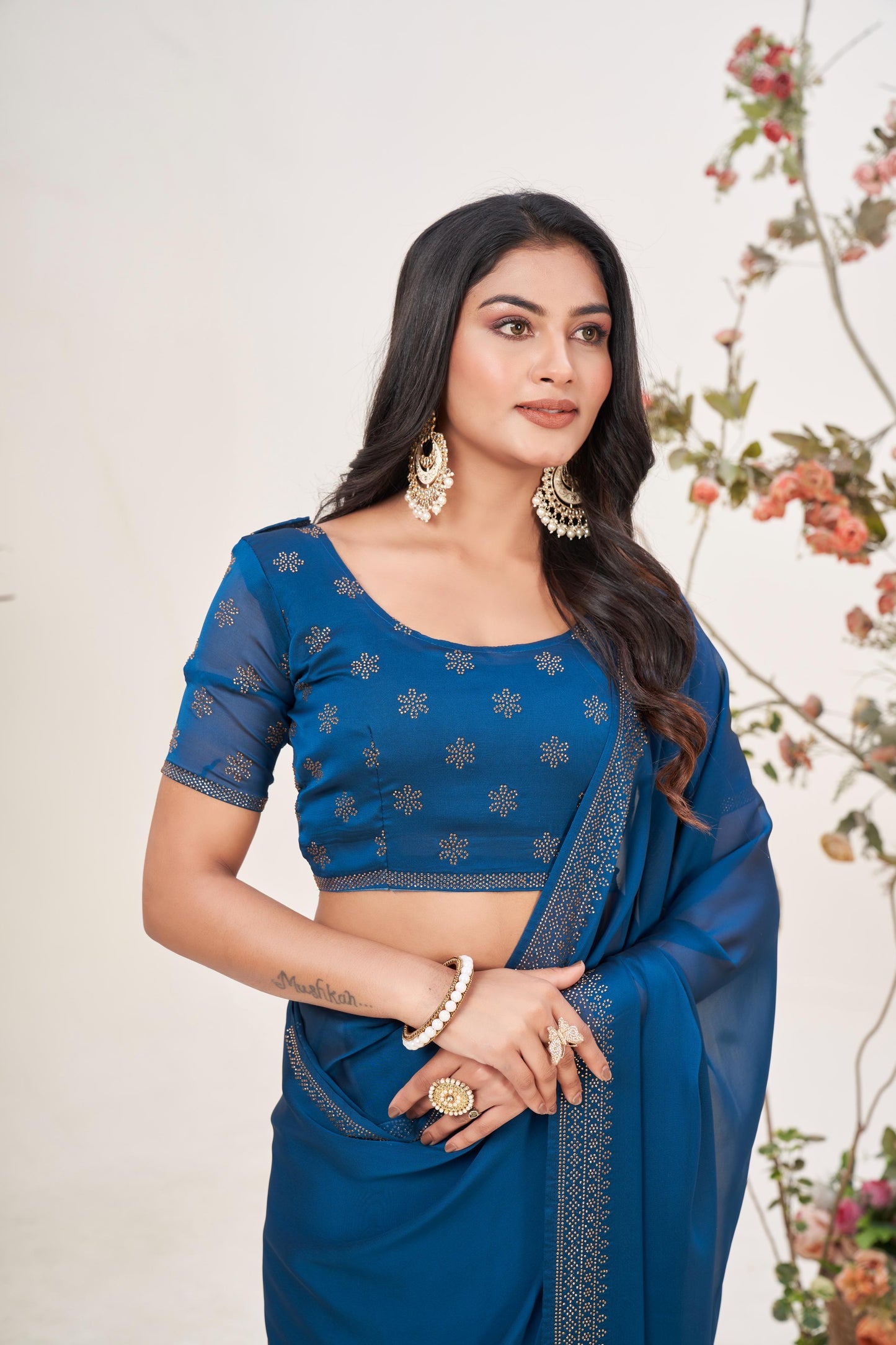Enchanting Turquoise Blue Georgette Saree with Sarvoski Stone Border