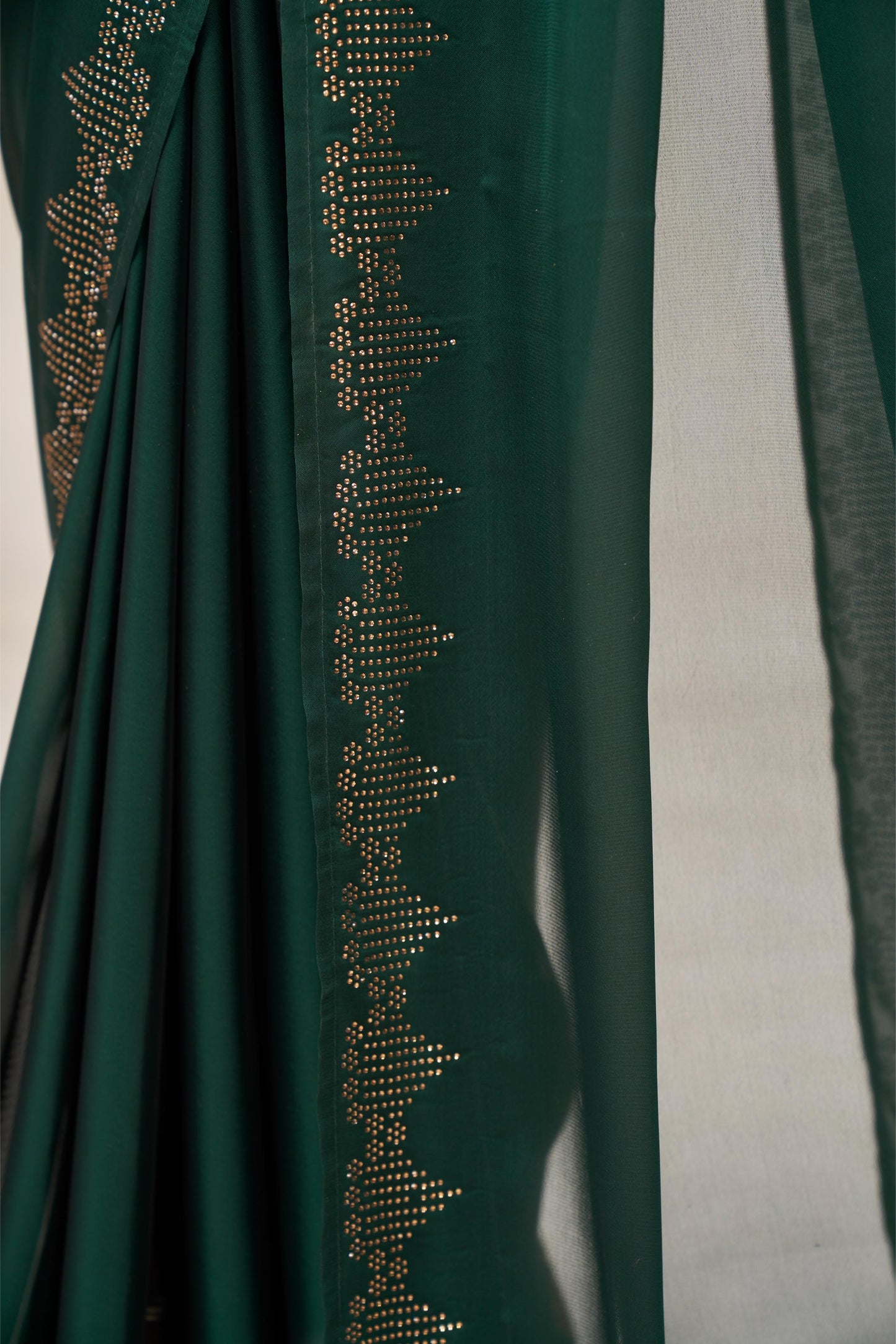 Regal Bottle Green Georgette Saree with Sarvoski Stone Border