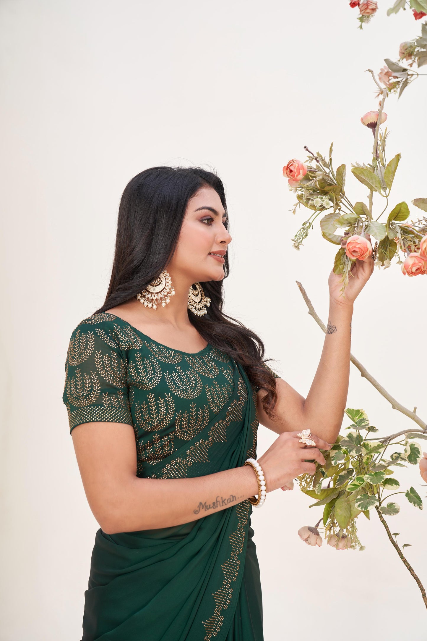 Regal Bottle Green Georgette Saree with Sarvoski Stone Border
