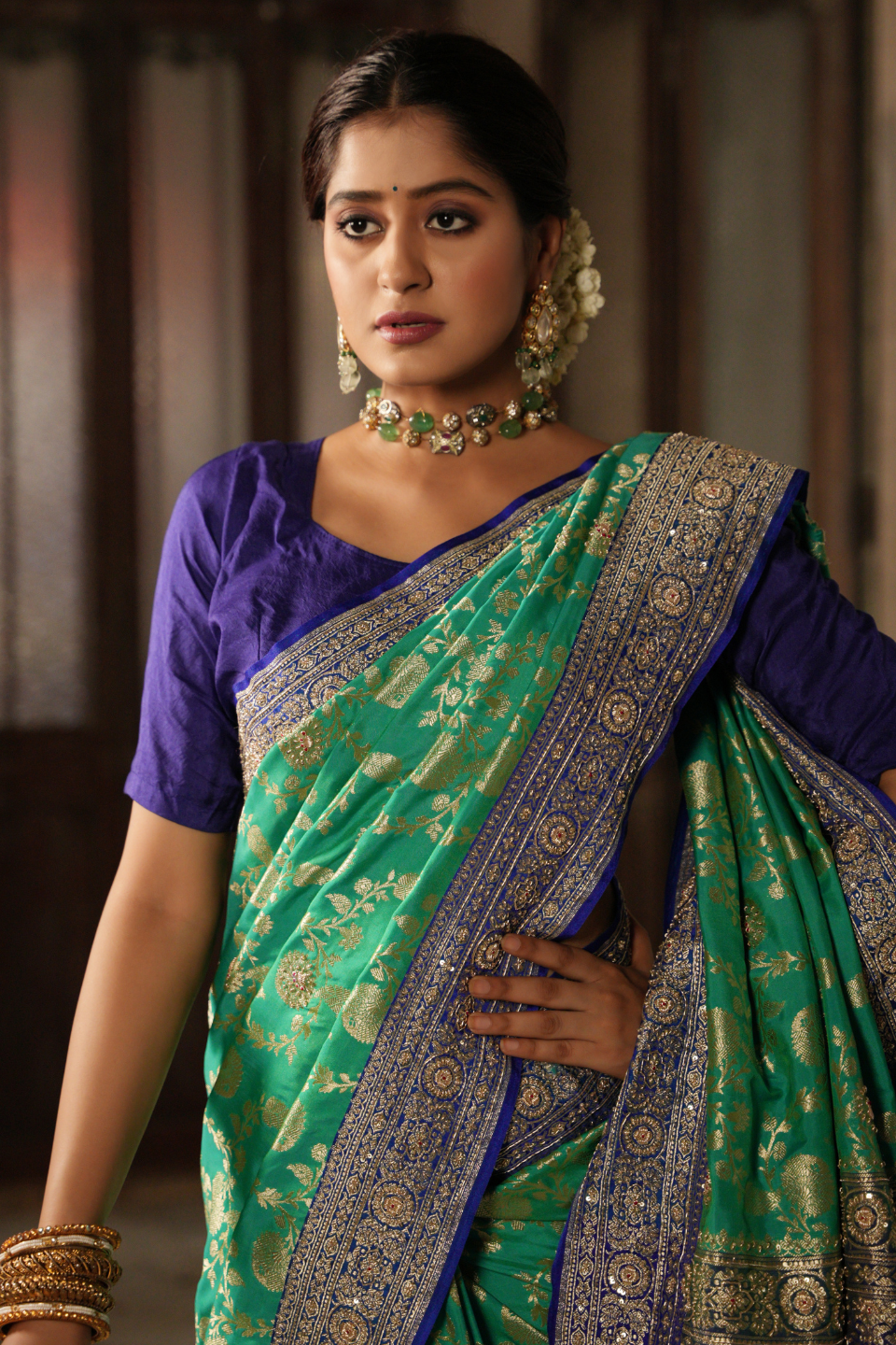 Emerald & Azure Elegance: Green Banarasi Silk Saree with Blue Zardozi-Adorned Border