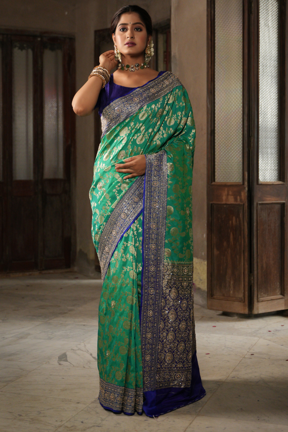 Emerald & Azure Elegance: Green Banarasi Silk Saree with Blue Zardozi-Adorned Border